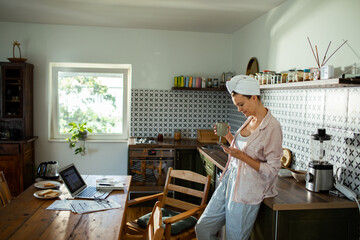 Woman reviewing bills and finances at kitchen table