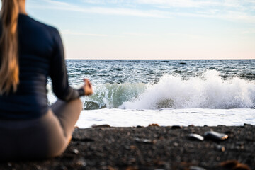 Yoga, meditation and spiritual woman on the beach with peace. Mindfulness, self care, healthy mindset. Female person breathing with holistic wellness in chakra. Sea background. Copy space. Back side.