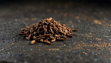 Dry hojicha tea leaves on stone.