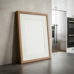 Wooden photo frame on a modern kitchen counter with stainless steel appliances