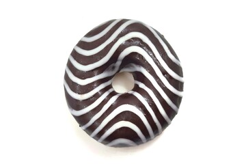 Top view of a chocolate donut with white icing stripes, isolated on a white background.