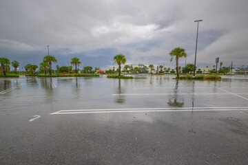 A parking lot submerged under heavy rain, with water pooling  creating  stormy scene.