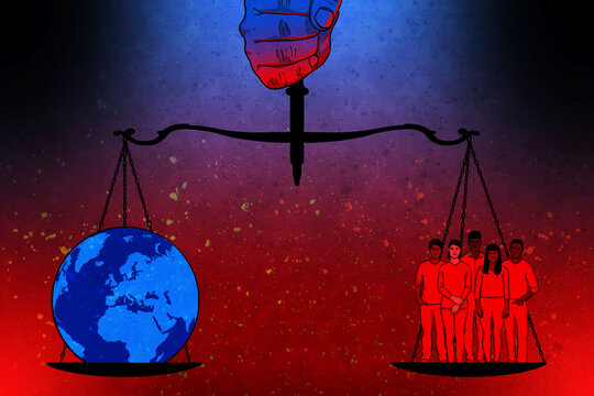 Hand holding weighing scales balancing group of people and the world