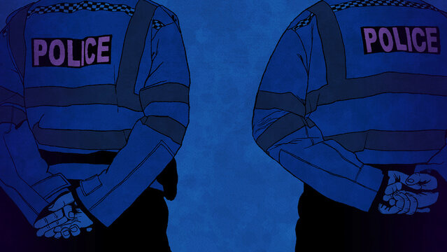 Rear view of two police officers standing guard on duty