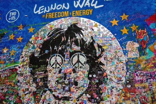 John Lennon Wall in Prague. Famous tourist sight with vibrant graffiti, peace symbols and tributes promoting freedom