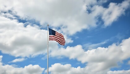 The US flag waves in the clear sky, showcasing national pride and spirit of independence