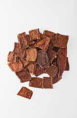 Natural dried treats for dogs. Treats for encouraging and training dogs. Animal care. Advertising treats for dogs, dried cow udder. Vertical photo