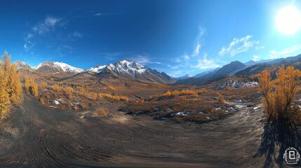 Obraz premium A panoramic view of a mountainous landscape with autumn foliage and snow-capped peaks.