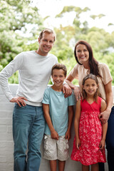 Family, portrait and smile in backyard together for love, bonding and security for connection. Parents, children and support for happiness in Switzerland home, kids and outdoor care in relationship