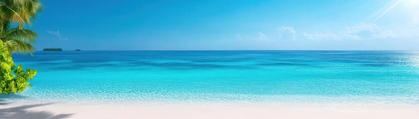 Fototapeta premium A serene beach scene featuring clear turquoise waters, soft white sand, and a bright blue sky, ideal for relaxation and vacation vibes.