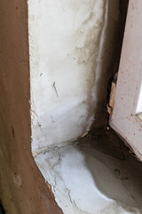 layers of fresh plaster in corner of window sill