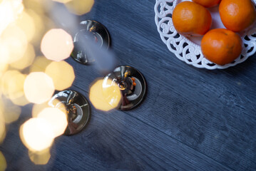 An exquisite display of three slender white candles perched on ornate silver holders, set on a sophisticated dark surface.
