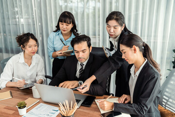 Diverse of business people from various ethnic group working in modern office environment. Productive and multi ethnic office workers engage in discussion for strategic business marketing. Meticulous