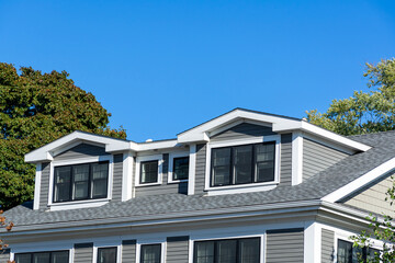 Modern residential home with dormer windows and gray siding in Brighton, Massachusetts, USA
