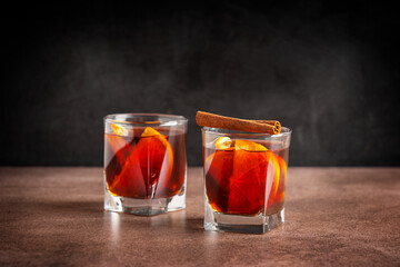Two glasses of homemade traditional winter red mulled wine drink or grog cocktail made with slices...