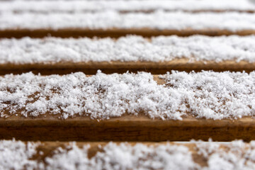 macro shot of snow on wooden planks, frosty details, winter texture, minimalistic design, close-up perspective, natural beauty, cold season atmosphere, outdoor scene