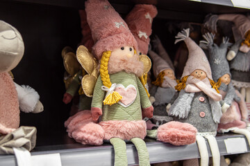 Christmas toys under the Christmas tree in the store on the shelf. Stuffed toys. Fairies and dwarfs