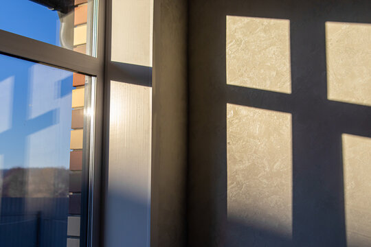 The rays of the sunset or dawn sun in the house on the wall. Winter solstice