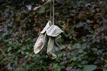 a green baby hat hangs on the tree
