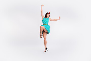 Full size photo of pretty girl jumping enjoy dancing wear teal retro style polka dot skirt isolated...