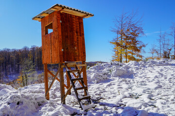 Sitting for hunters on the edge of the field and forest. A hunter's pulpit hidden in the forest for...