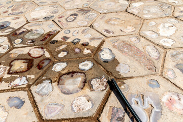 Hexagonal stone tiles with embedded agate stones displaying various colors and patterns