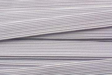 close-up of white knitted elastic bands abstract background, commonly used in textile industry...
