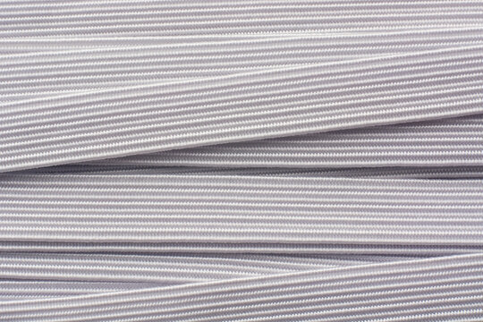close-up of white knitted elastic bands abstract background, commonly used in textile industry garments, sportswear and lingerie