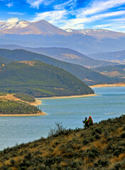 Hikers look out at Lake Dillon in Summit County, Colorado