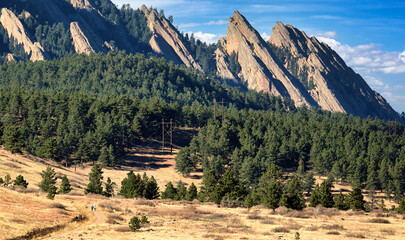 Hikers on Boulder, Colorado's Mesa Trail, with the Flatirons in the background