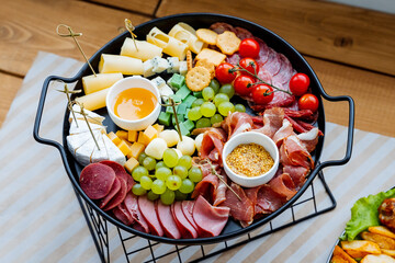 On the table sits a beautifully arranged plate of food that includes delicious pieces of meat,...