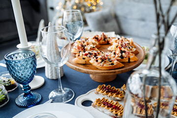 A beautifully arranged table that showcases an enticing variety of delicious foods alongside elegant wine glasses, significantly enhancing its overall aesthetic appeal and inviting ambiance
