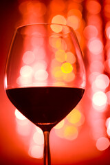 Red Wine Glass with Bokeh Lights Background