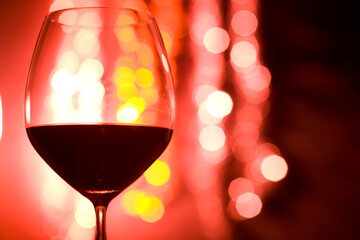 Red Wine Glass with Bokeh Lights Background 