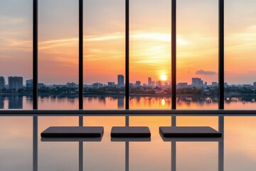 Sunset view over city skyline from modern building with large windows