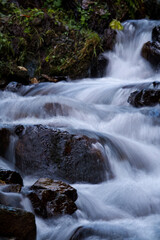 water from a mountain creek in long exposure photography at a cold autumn day