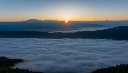 Obraz premium Mystic valley with clouds, distant mountains at dawn.