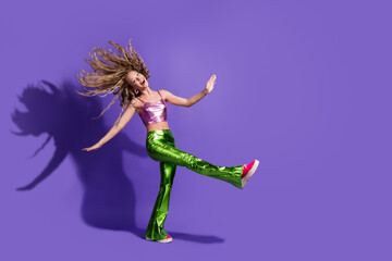 Full body portrait of nice young girl dance flying hair wear shiny outfit isolated on purple color...