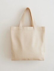 Minimalist Beige Tote Bag Hanging by Its Handles Against Wall