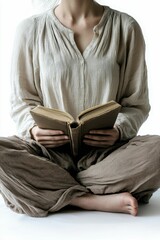 Person seated, reading old book, neutral clothing.