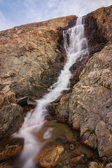 Beautiful waterfall in the Qalerallit fjord and glacier (South of Greenland)