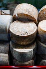 An assortment of cheese varieties is artistically stacked, creating a visually appealing display...