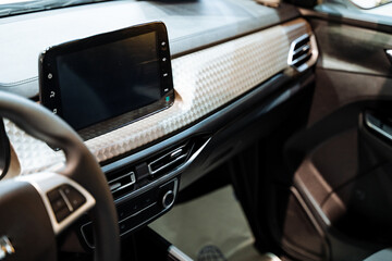 The interior of a car encompasses essential components such as the steering wheel and radio, which play a vital role in ensuring safe driving and providing entertainment throughout travel