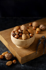 Mix nuts in wooden bowl. Almonds, hazelnuts, cashews, walnuts. Copy space