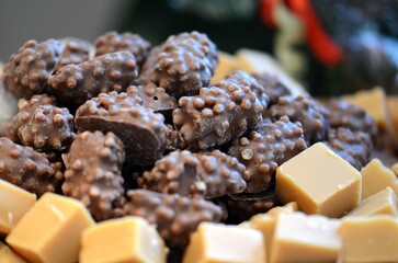 A closeup shot of a bowl of wafer chocolate and butterscotch candy.