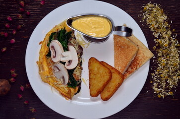 Spanish omelette with spinach and mushroom, served with toast bread.
