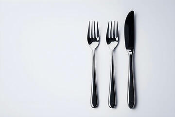 Elegant Silver Cutlery Set Featuring Forks and Knife on Minimalistic Light Background