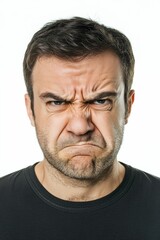 Obraz premium Angry man's face, dark shirt, close-up.