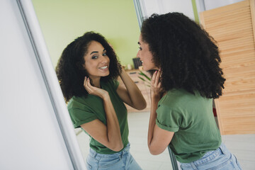 Photo of pretty young girl hands touch curly hair mirror wear t-shirt weekend pastime apartment...