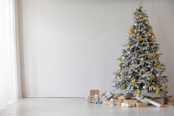 White Christmas tree with gifts garlands in the interior for the new year